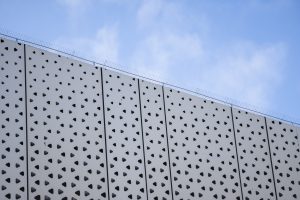 Architecture detail of a modern building with a blue sky on background. Facade design.